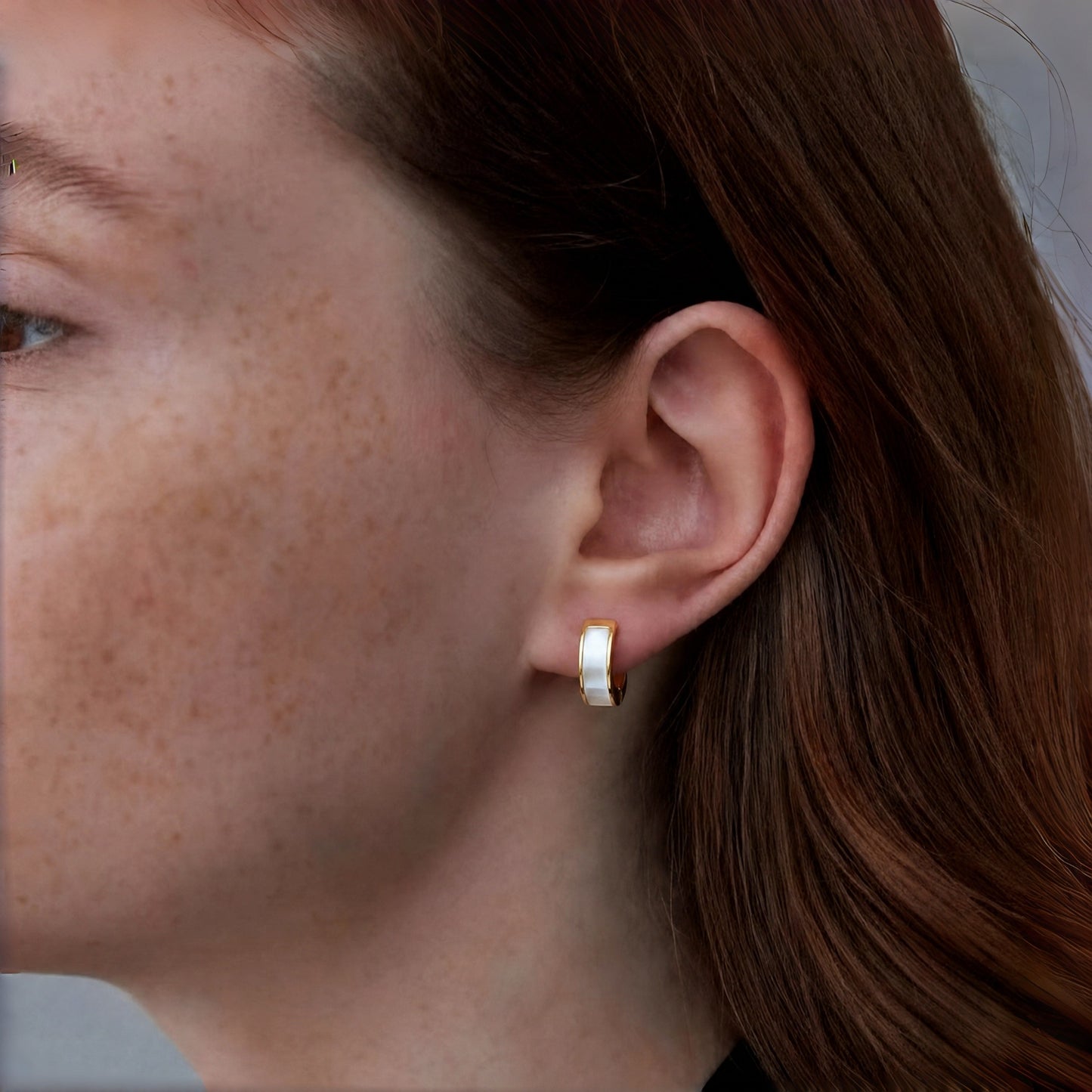 Model wearing Lunar Hush sterling silver hoop earrings.