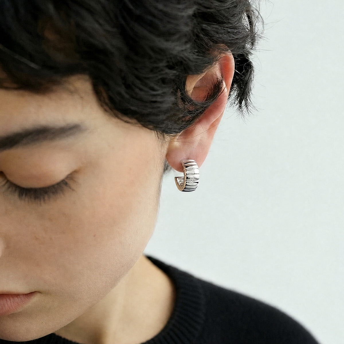 Model wearing Twilight Path sterling silver hoop earrings.