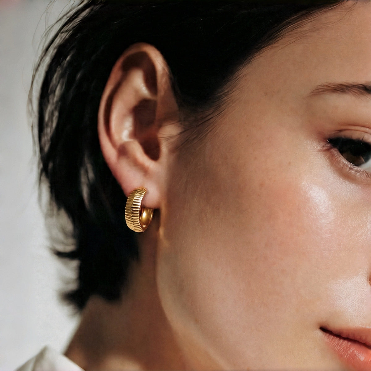 Model wearing Peak Light sterling silver earrings