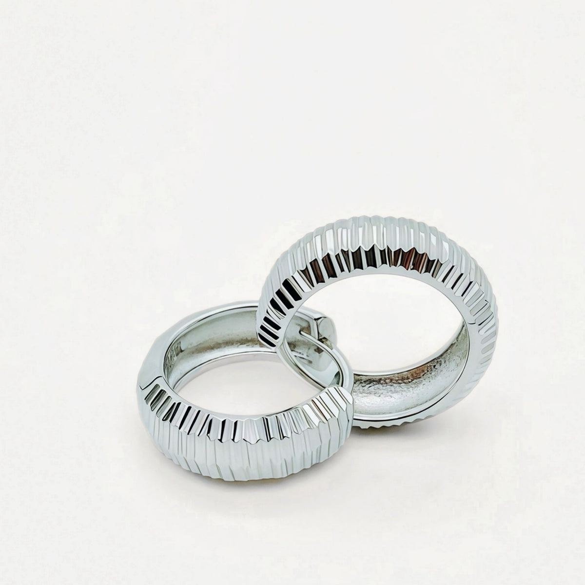 Close-up of Peak Light sculptural sterling silver earrings