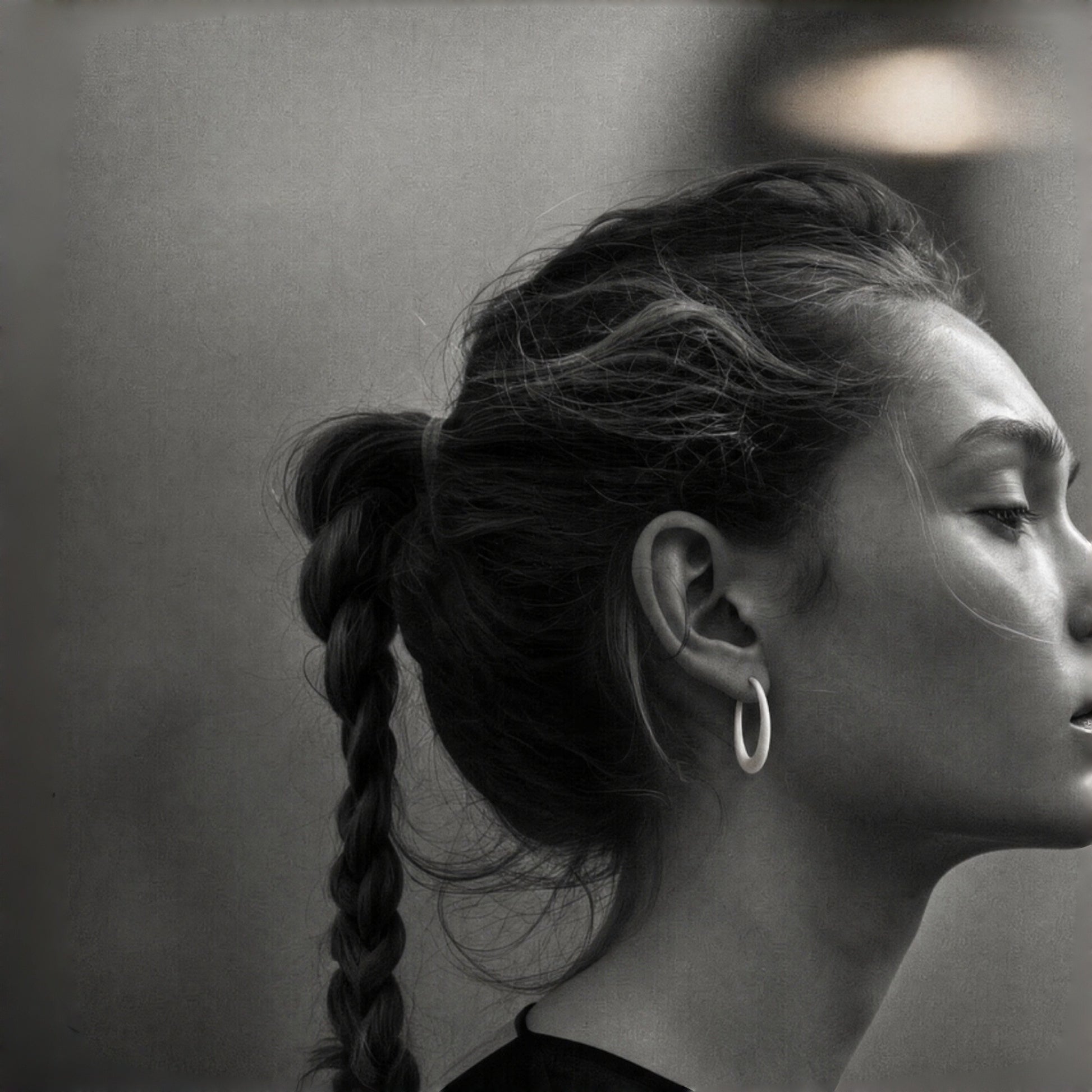 Model wearing Quiet Loop sterling silver earrings