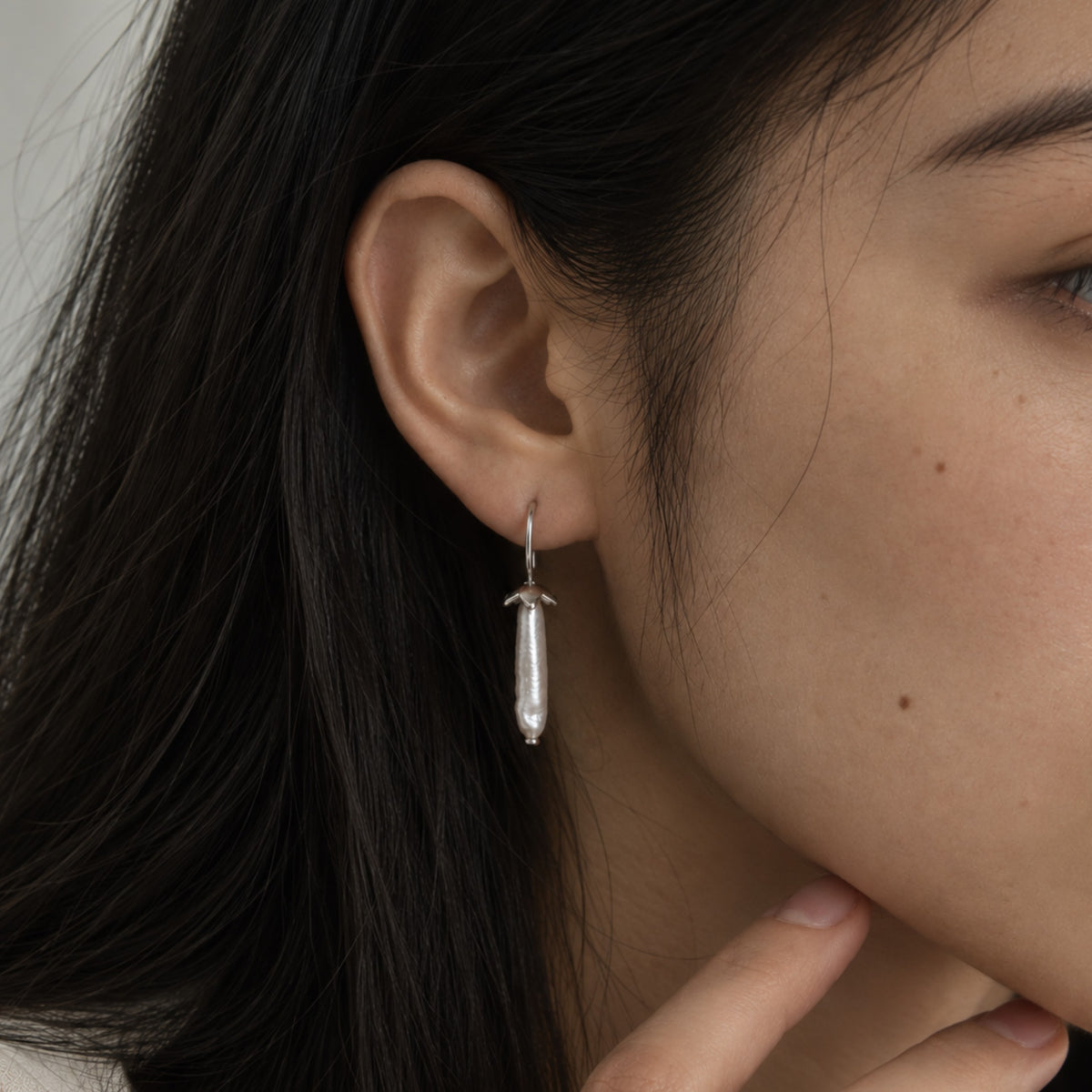 Vesper Light baroque freshwater pearl earring worn on the ear