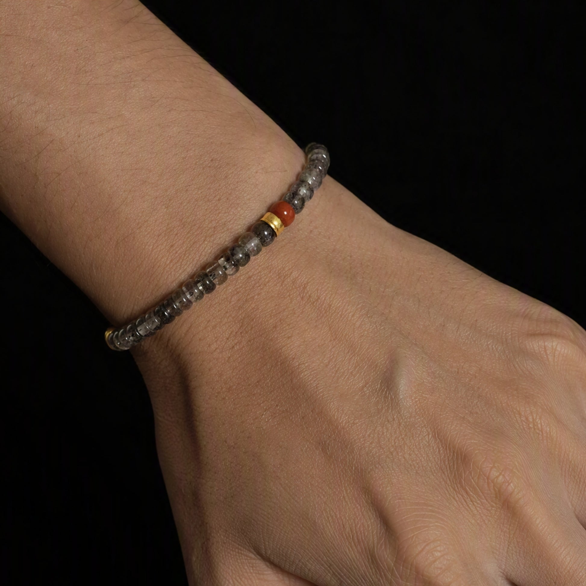 Crest 01 natural Herkimer quartz bracelet with Nanhong agate red accent worn on the hand