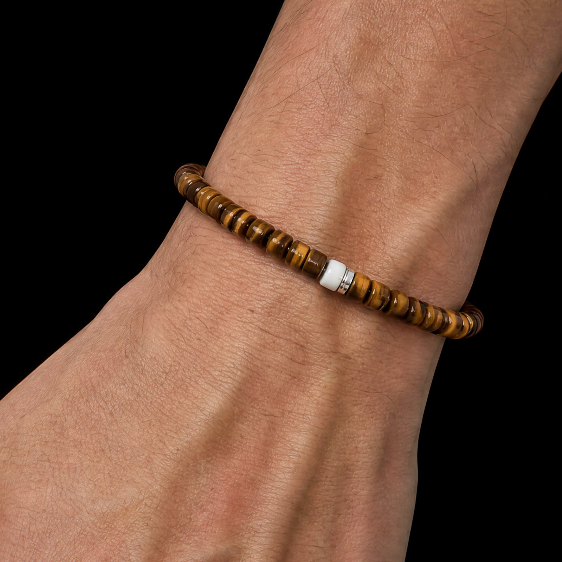 Terra 01 tiger eye bracelet with fossil mammoth ivory and sterling silver worn on the wrist
