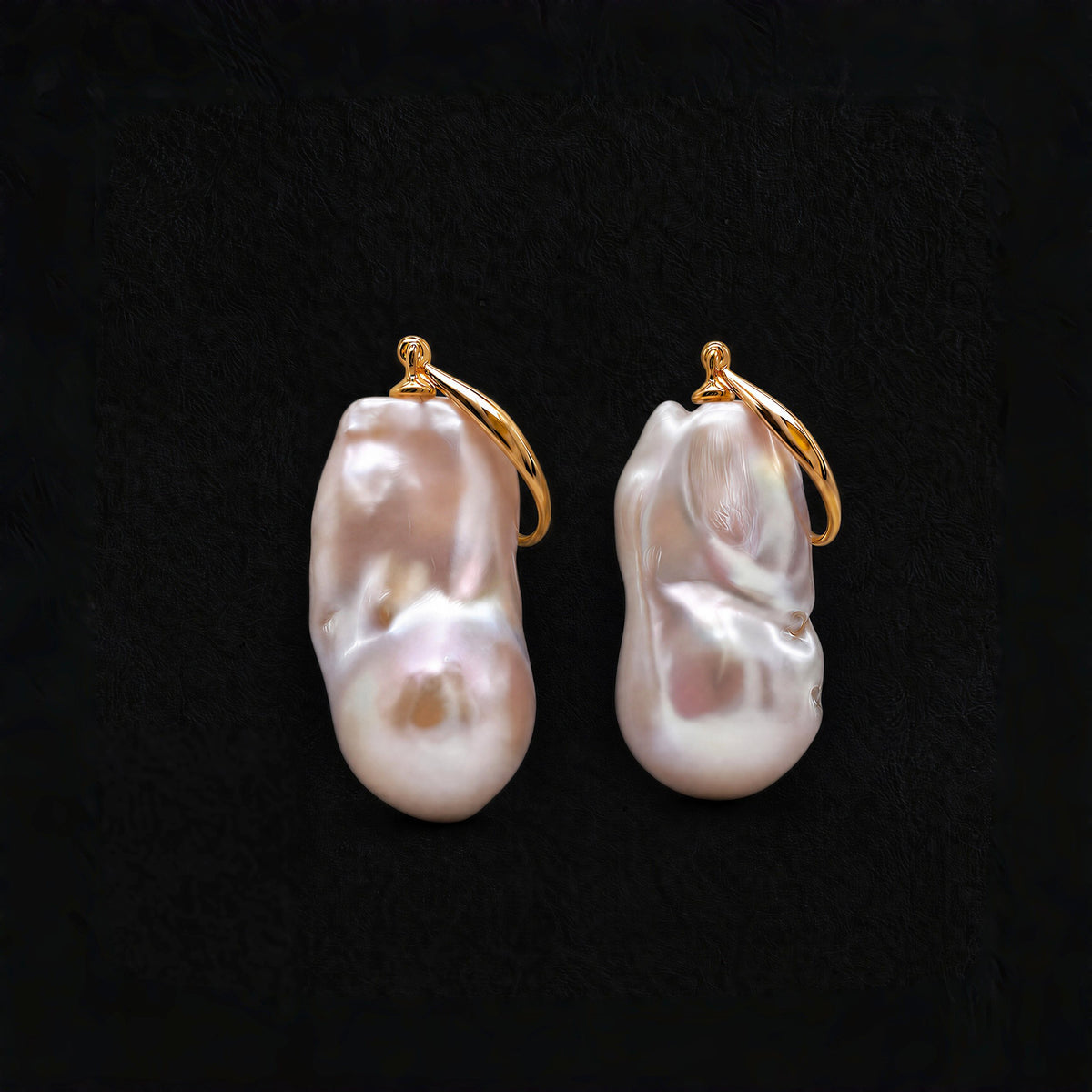 Tide Stone freshwater baroque pearl earrings with gold-plated silver details on a black background.
